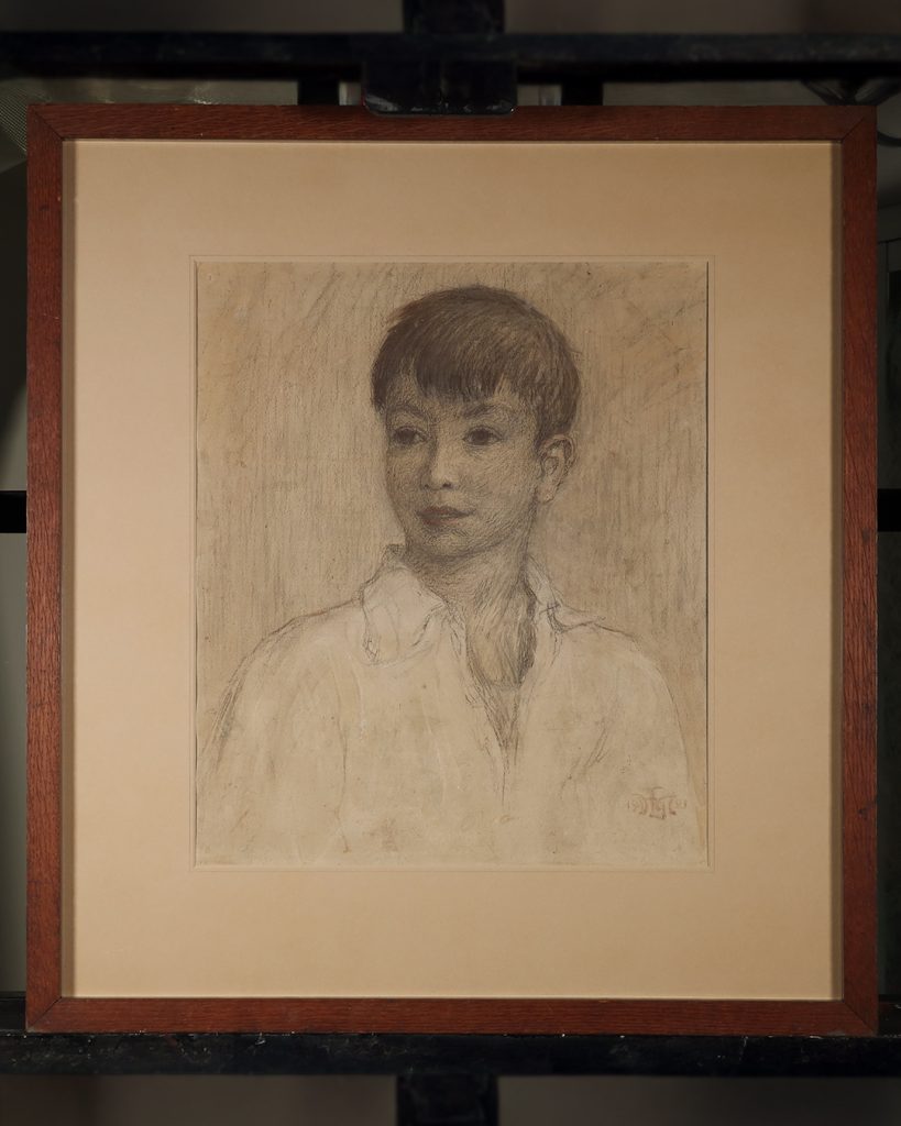 A frame portrait of a boy aged approx. 10 years in charcoal, chalk and pastel.