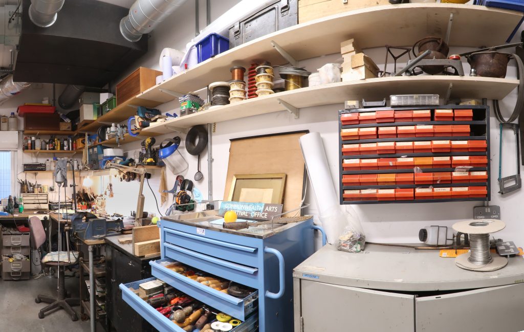 Panoramic view of the Plowden & Smith metals workshop interior showing tools storage and workbenches