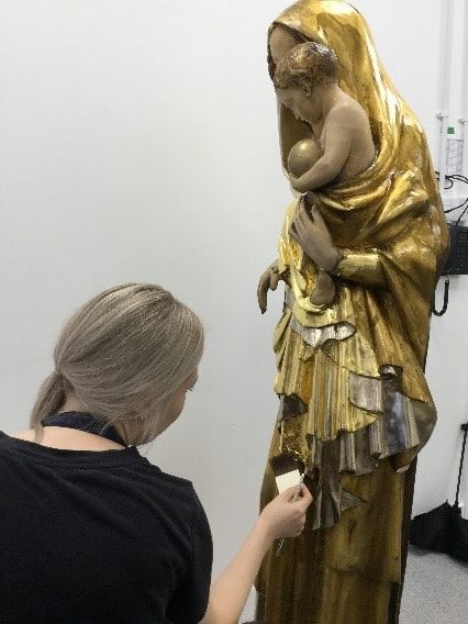 Our Lady of Peace statue being gilded in the Plowden & Smith gilding studio