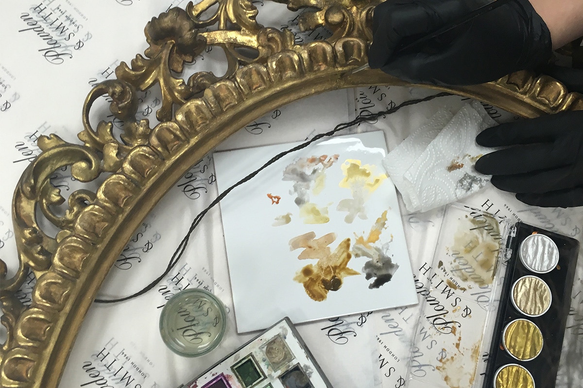 toning in a gilt picture frame in the Plowden & Smith gilding studio